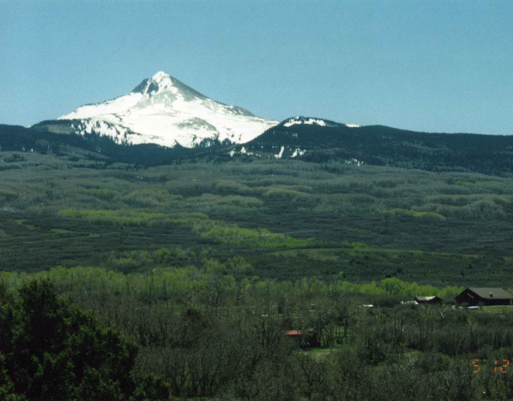 Snow-capped Lone Cone mountain seen from the lodge porch